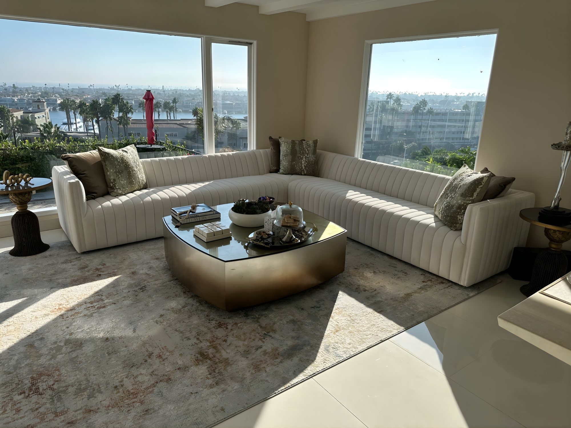 Channel tufted living room with harbor view and brass table